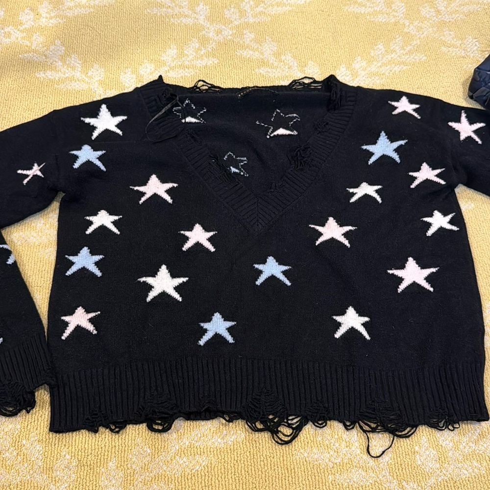Distressed start sweater